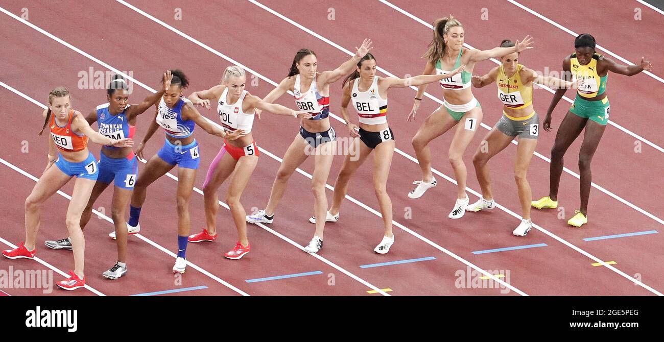 Runners wait to receive their batons during the 4x400-meter mixed relay ...
