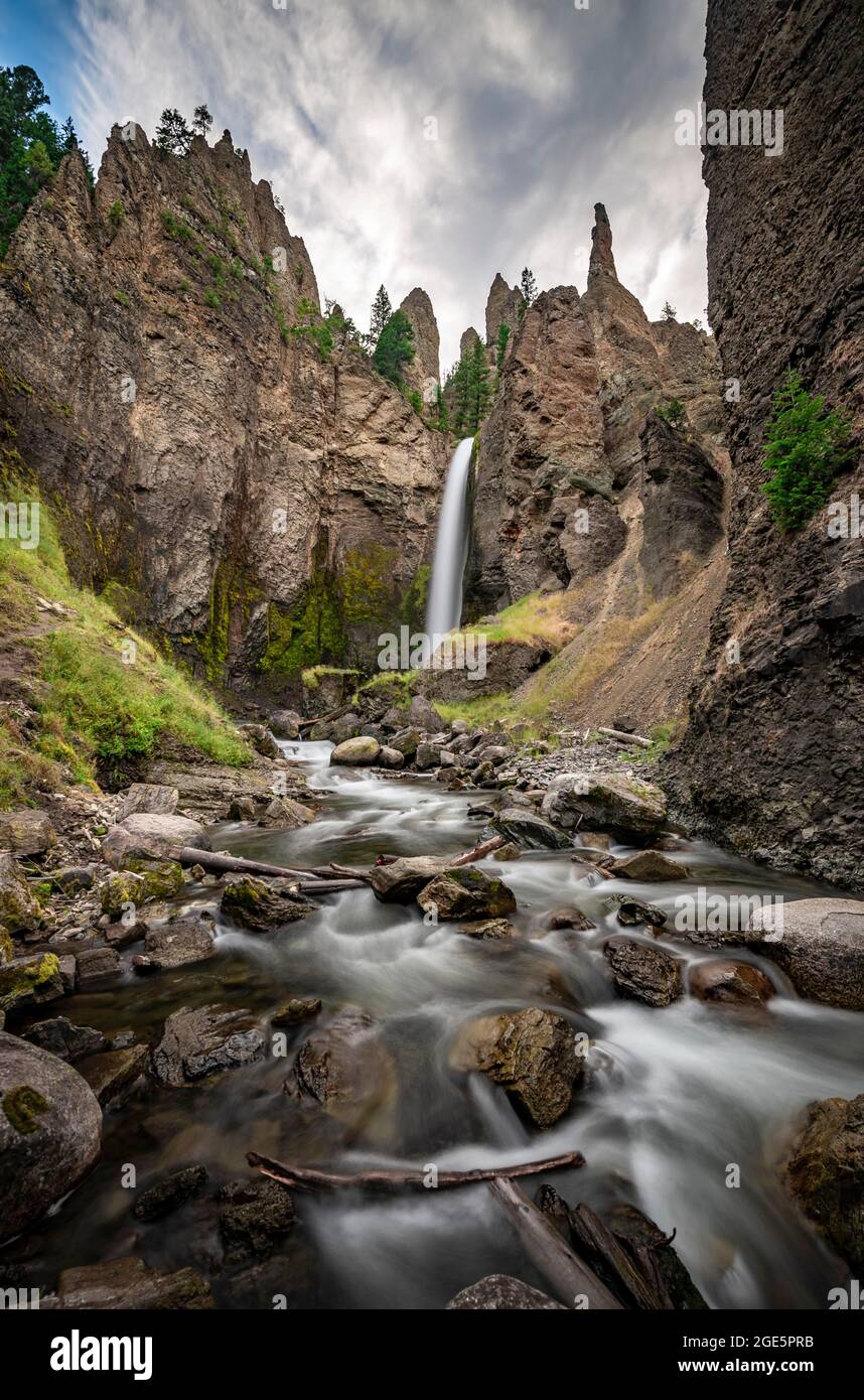 Waterfall flowing through eroded landscape with rock outcrops, Tower Fall with Tower Creek, Yellowstone National Park, Wyoming, USA Stock Photo