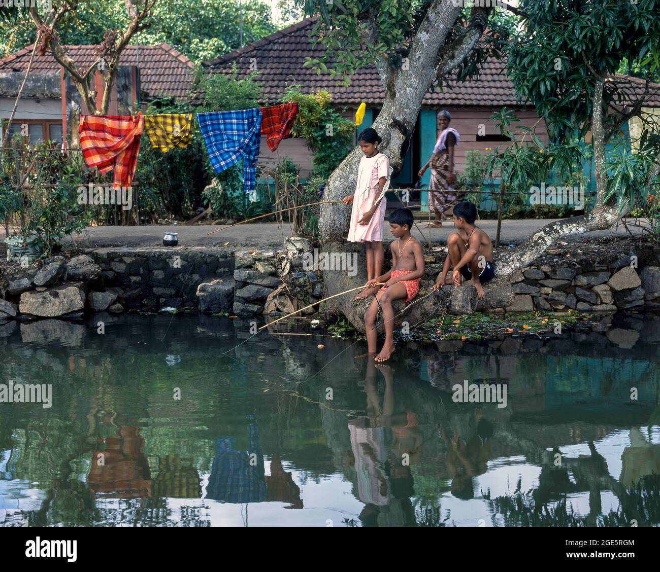 Children fishing in the Backwaters of Kuttanad, Alapuzha; Aleppey, Kerala, India Stock Photo