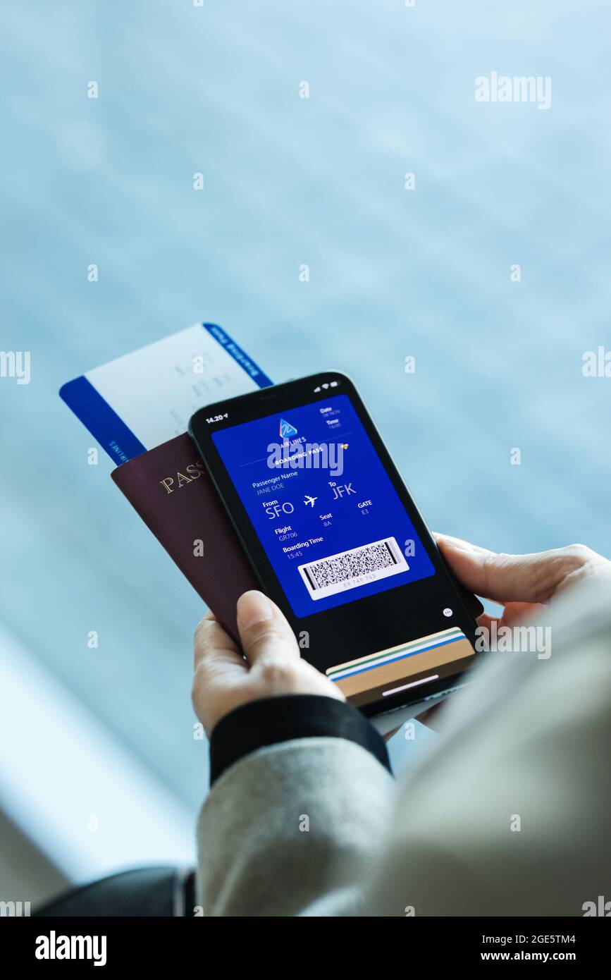 Passenger holding smartphone checking travel information on electronic