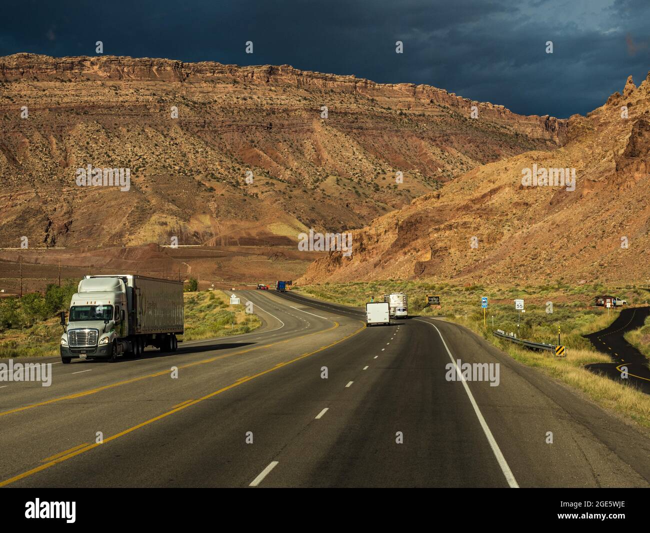 Truck on highway towards Arches Scenic Drive and Arches National Park