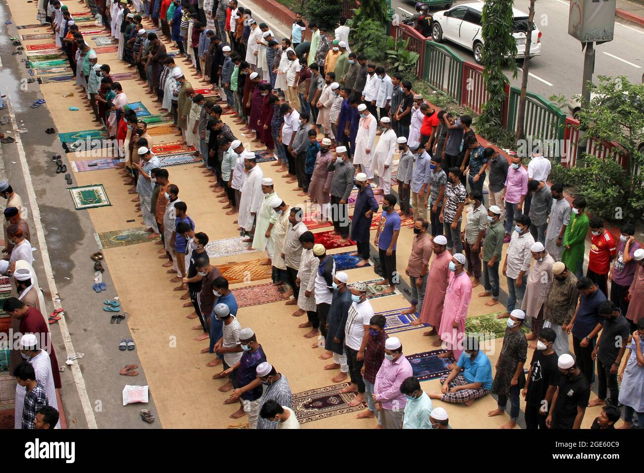 DHAKA, BANGLADESH  -AUGUST 13: Aerial view of thousands of Muslims meeting  take part during a mass  Jummah Prayer, Due this Islamic ritual is mandatory act, it is performed every Friday to fulfill its obligations as a faithful.  Jummah is the holiest day of the week on which special congregational prayers are offered. Fridays are considered a celebration in their own right and Muslims take special care in wearing clean clothes, bathing, and preparing special meals on this day. On August 13, 2021 in Dhaka, Bangladesh. Credit: Eyepix Group/The Photo Access Stock Photo