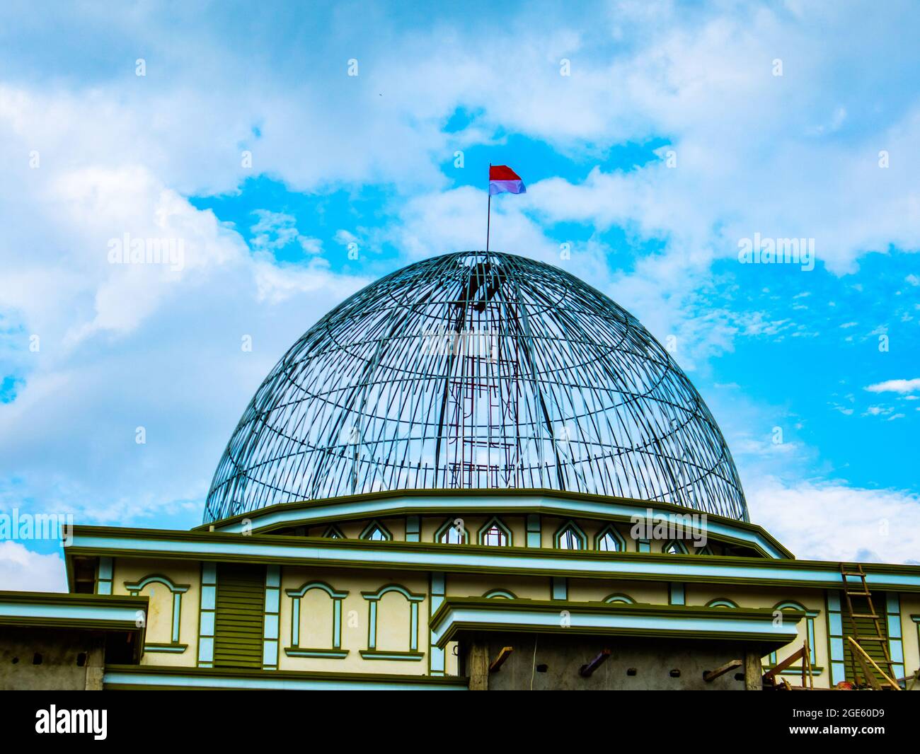 A dome of the mosque still under construction flies over the Indonesian