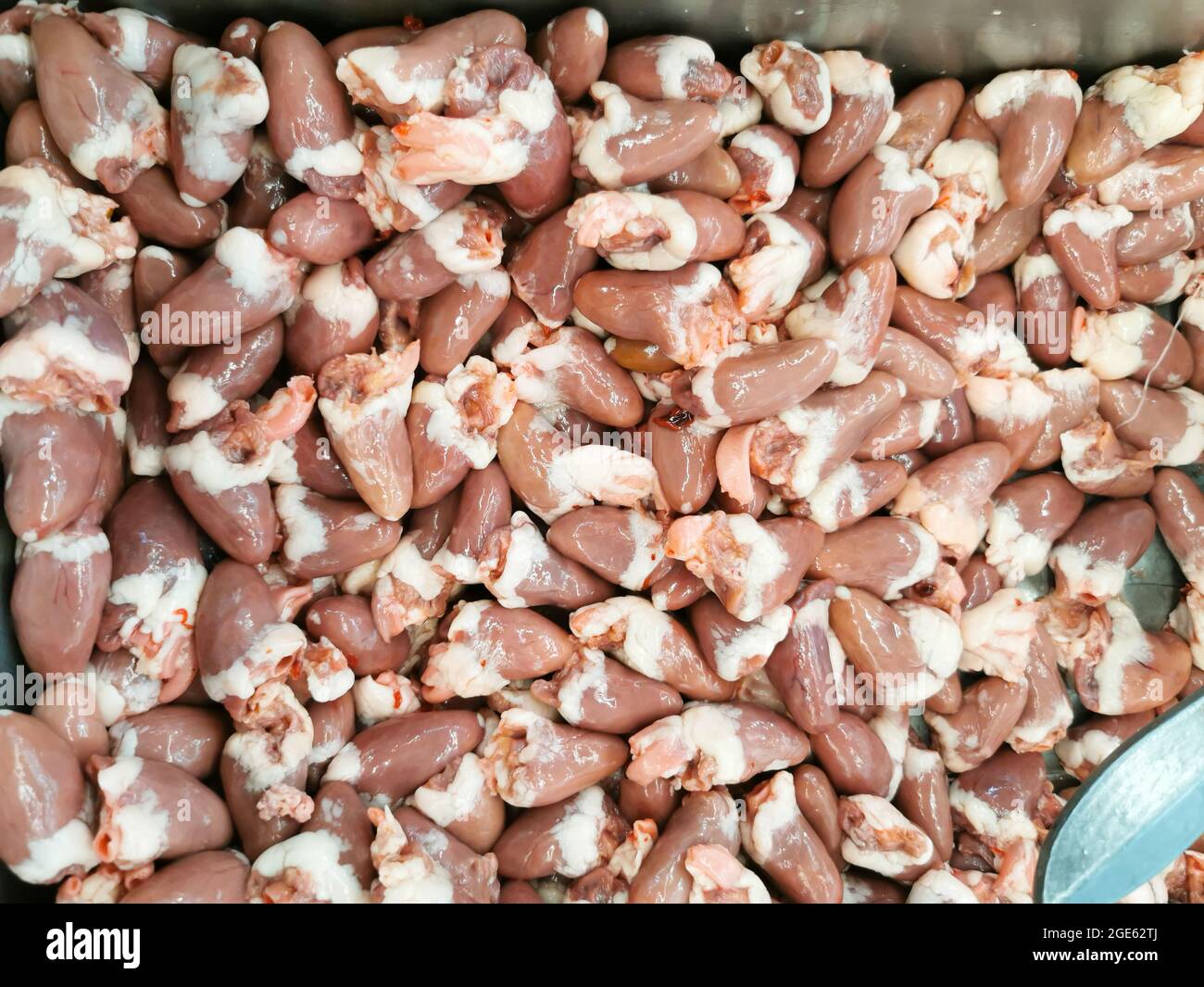 High angle view of chicken hearts on the tray, selling at meat shop. Stock Photo