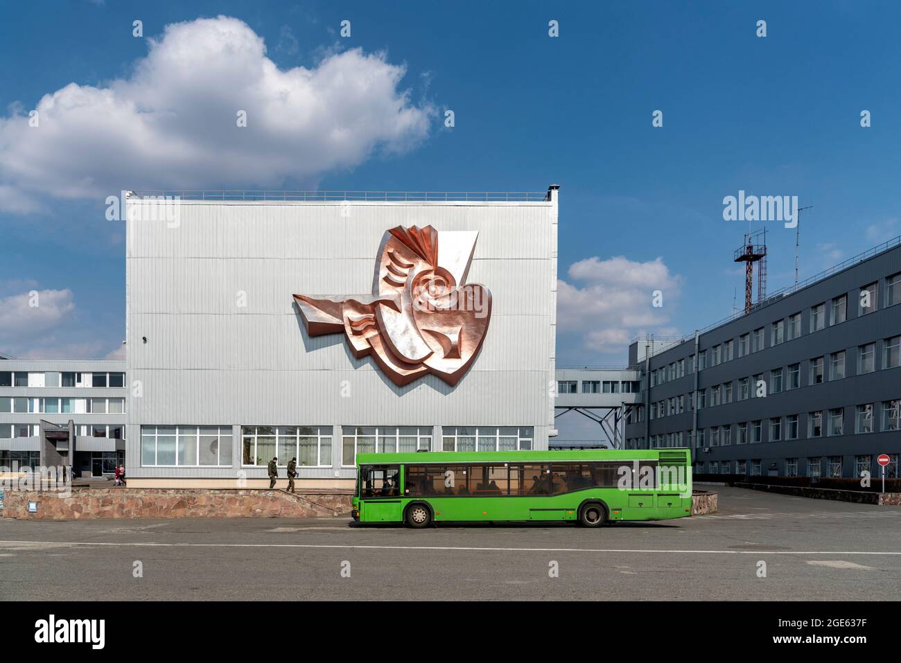 Green bus waiting workers in front of ABK-1 Administration Building of the Chernobyl Nuclear Power Plant. Stock Photo