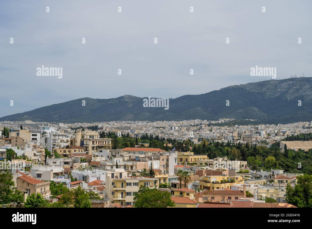 Cityscape of Athens at cloudy day. City near mountain. Urban architecture in Europe. View from top. Stock Photo