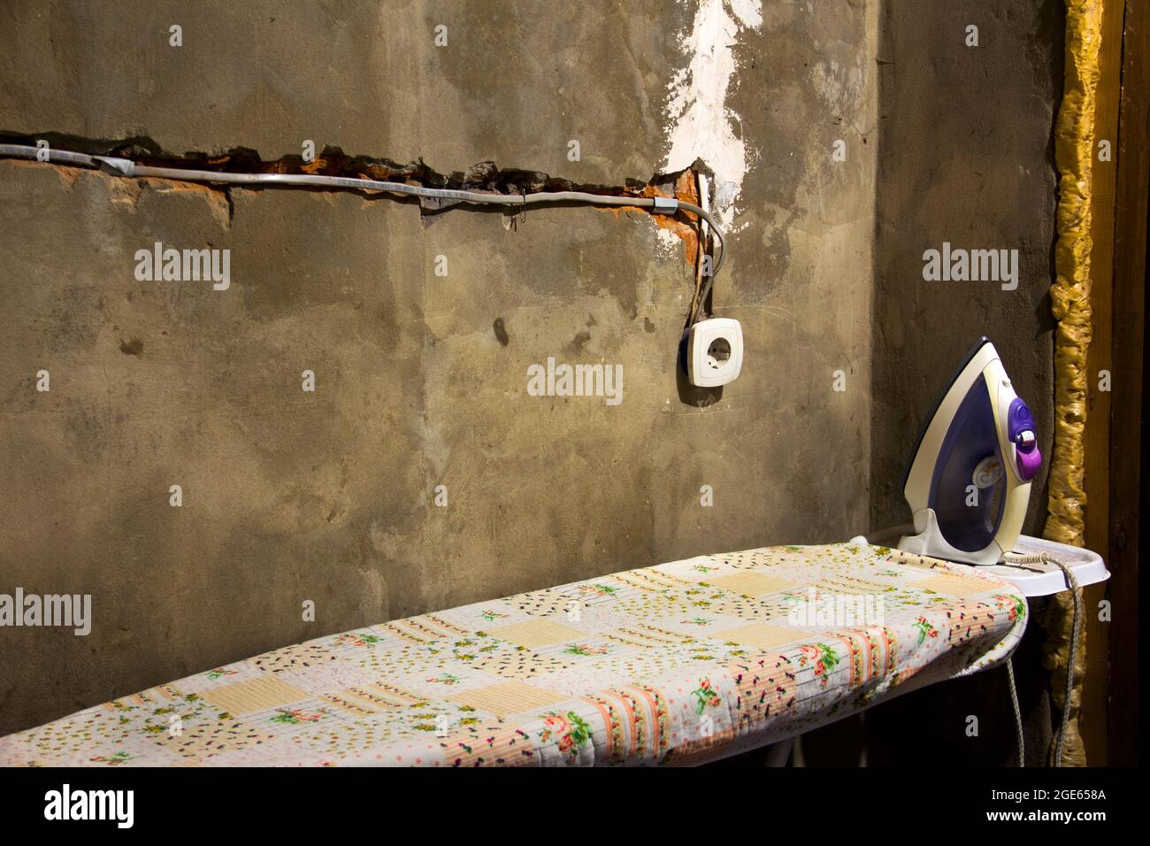 Socket. Iron and ironing board. Repair in the house. Electricity wiring. Socket. Wires