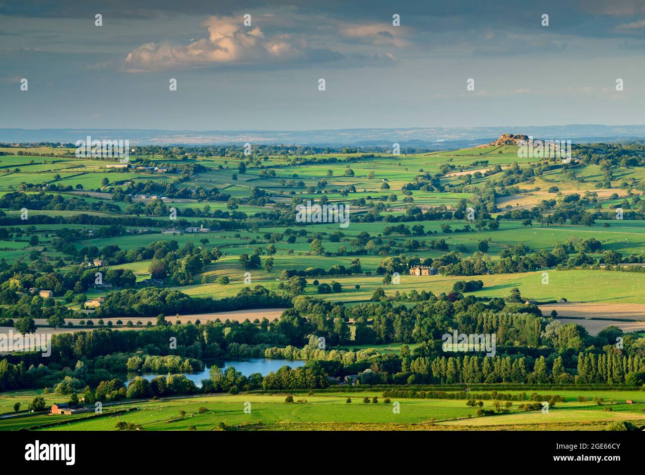 Scenic countryside view of Wharfedale from Otley Chevin (wide green sunlit valley, farmland fields, high crag, blue sky) - West Yorkshire, England UK. Stock Photo