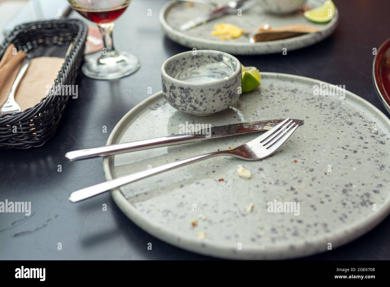 Three empty plates after meal is finished, with forks and knives. dirty plates after dinner