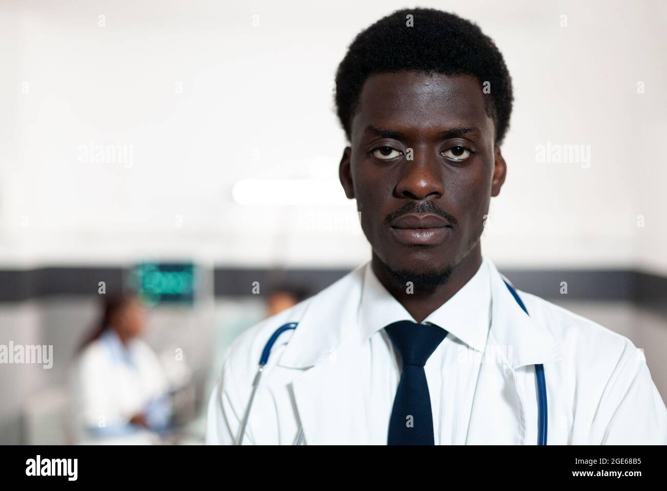 Portrait of african american doctor looking at camera in hospital ward ...