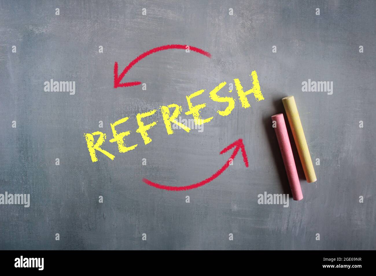 Chalkboard and text REFRESH on cement floor Stock Photo