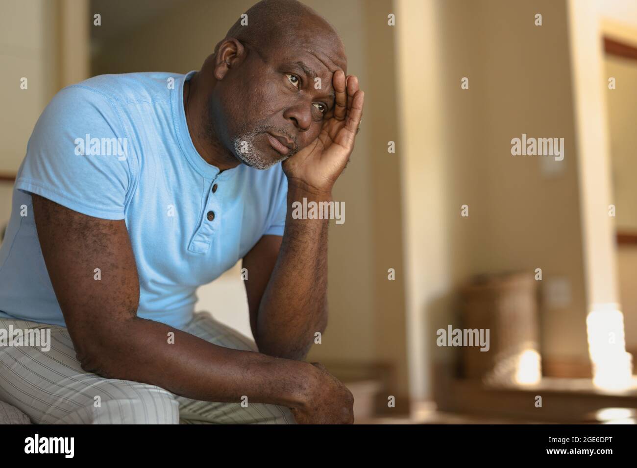 Thoughtful senior african american man siting on the bad and thinking Stock Photo
