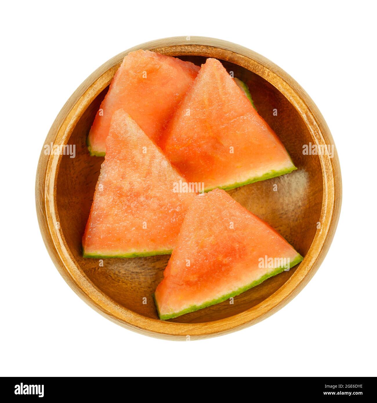 Watermelon slices, in a wooden bowl. Triangular and ready-to-eat pieces of a freshly cut, ripe and seedless fruit of Citrullus lanatus. Stock Photo