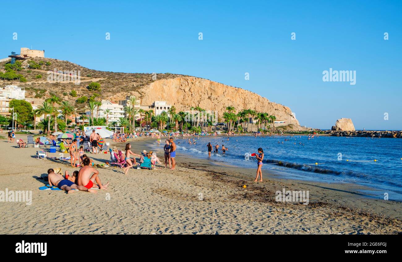 AGUILAS, SPAIN - JULY 31, 2021: Some people enjoying in the Ponente beach, also known as La Colonia beach in Aguilas, Region of Murcia, Spain, with th Stock Photo