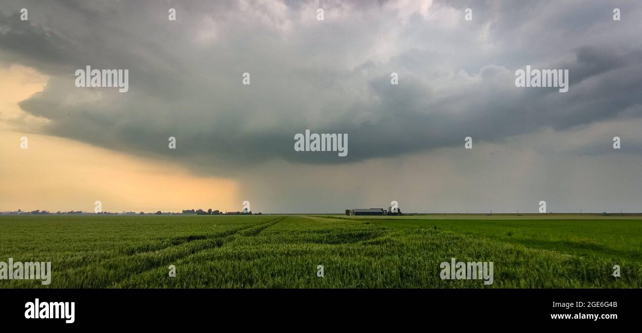 Panorama of an ominous looking thunderstorm with distinct updraft and
