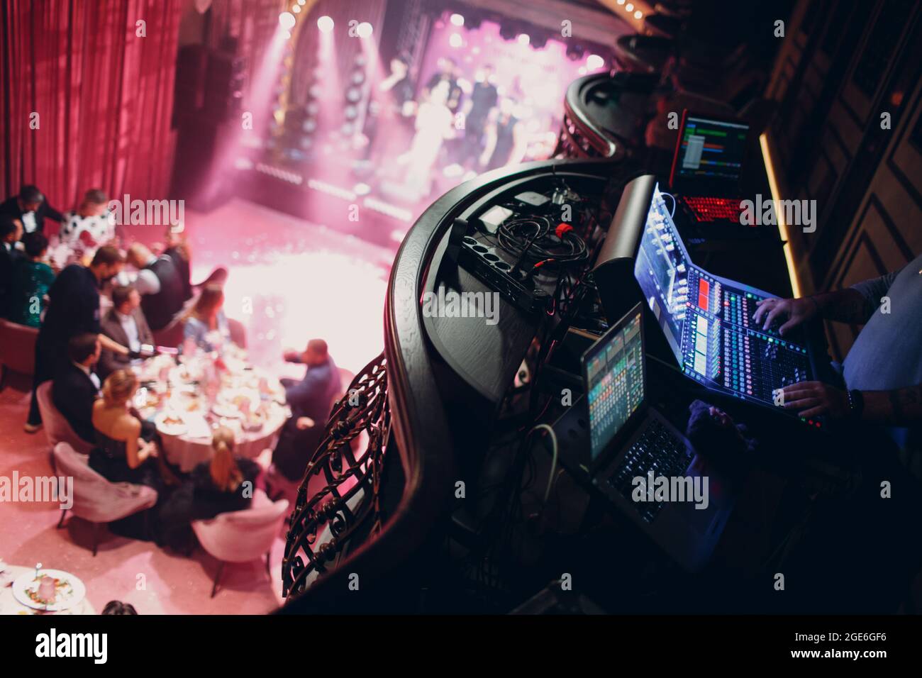 Mixing console, hand equalizing audio sound channels in night club