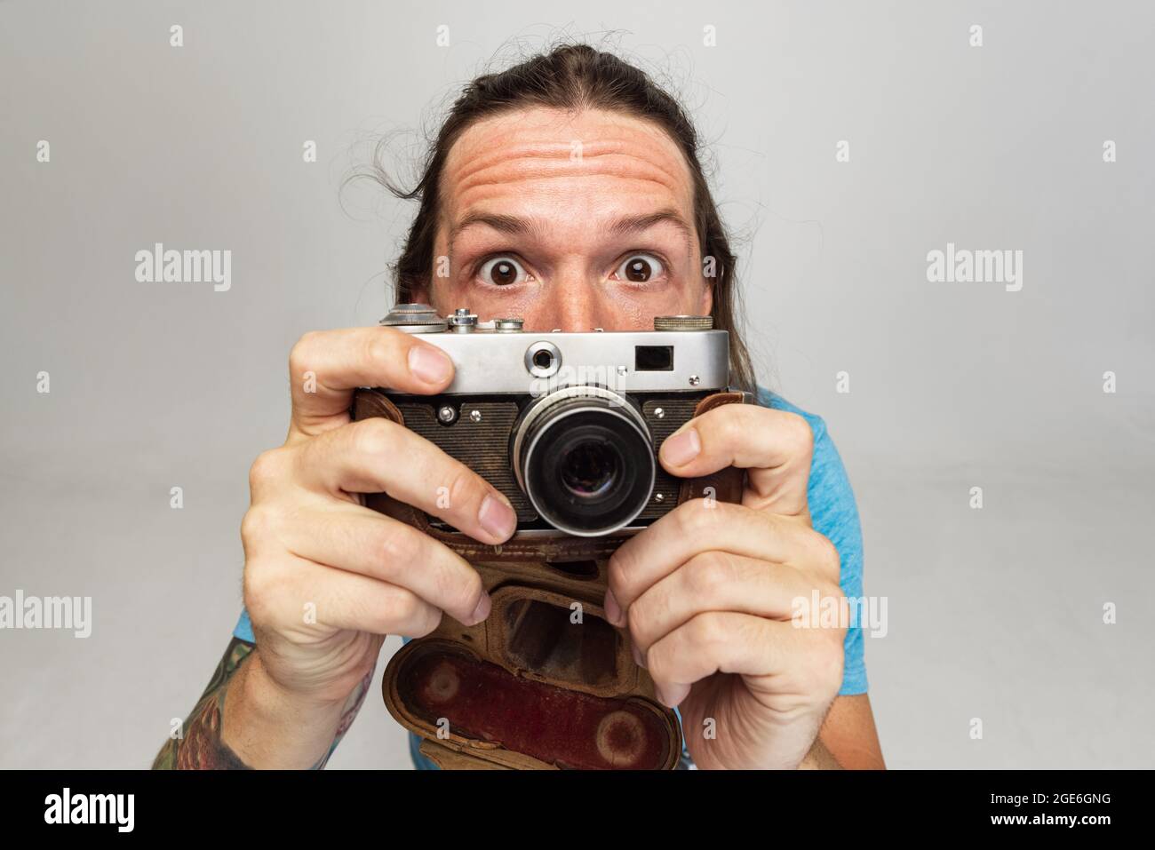 High angle view of young man, photographer, cameraman with retro camera