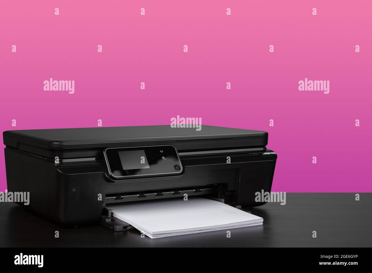 Compact home laser printer against pink background Stock Photo