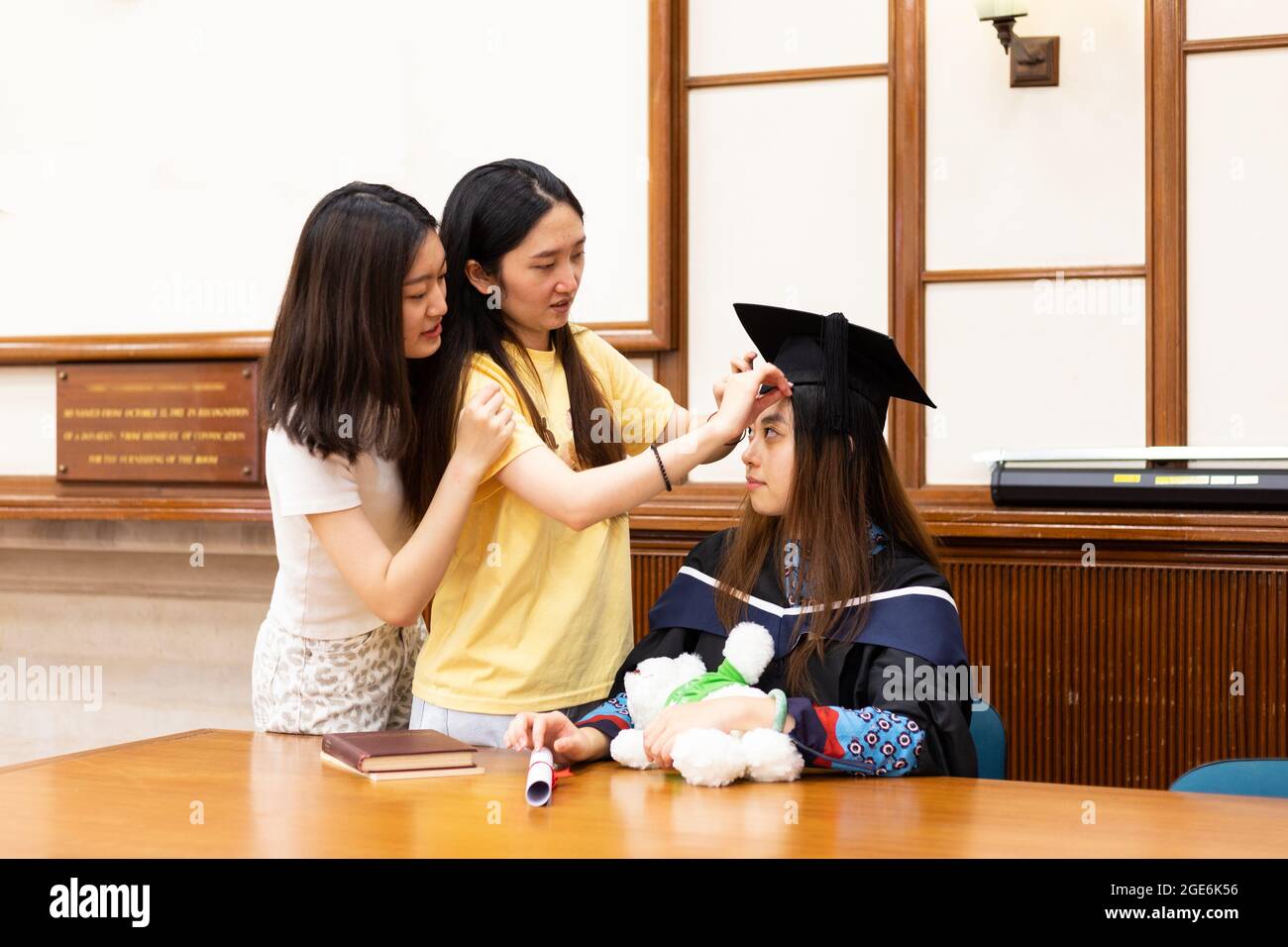 Graduation Support happy and cheerful Female university graduate students help each other ...