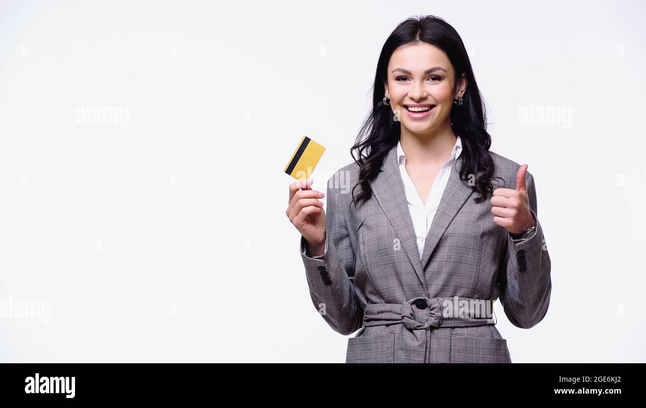 Positive manager holding credit card and showing thumb up isolated on white Stock Photo