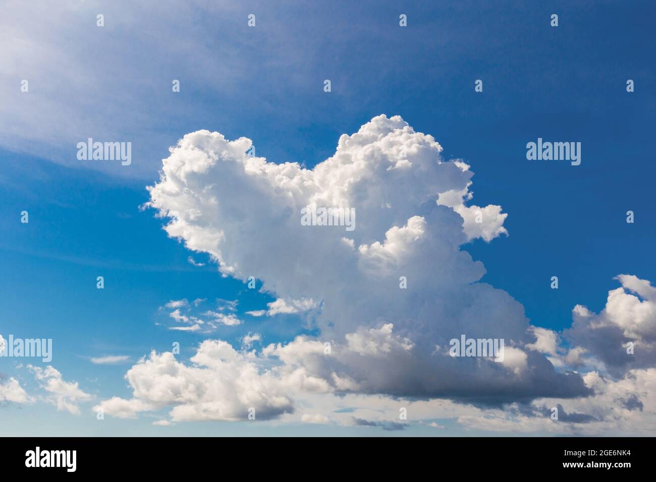 Heart shaped cloud on bright blue sky and white clouds. Stock Photo
