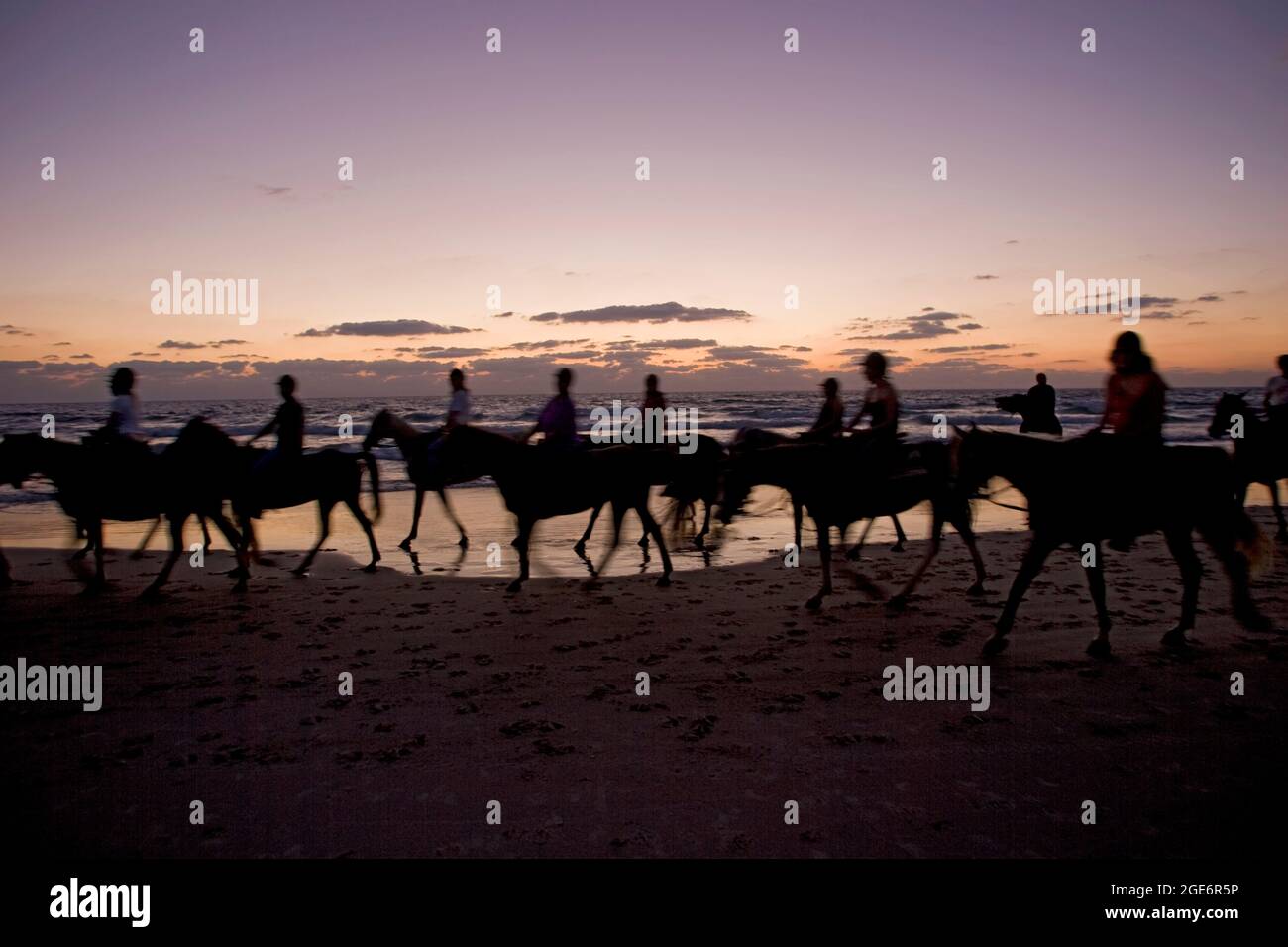 Silhouetted horse riders on the beach at sunset Stock Photo - Alamy