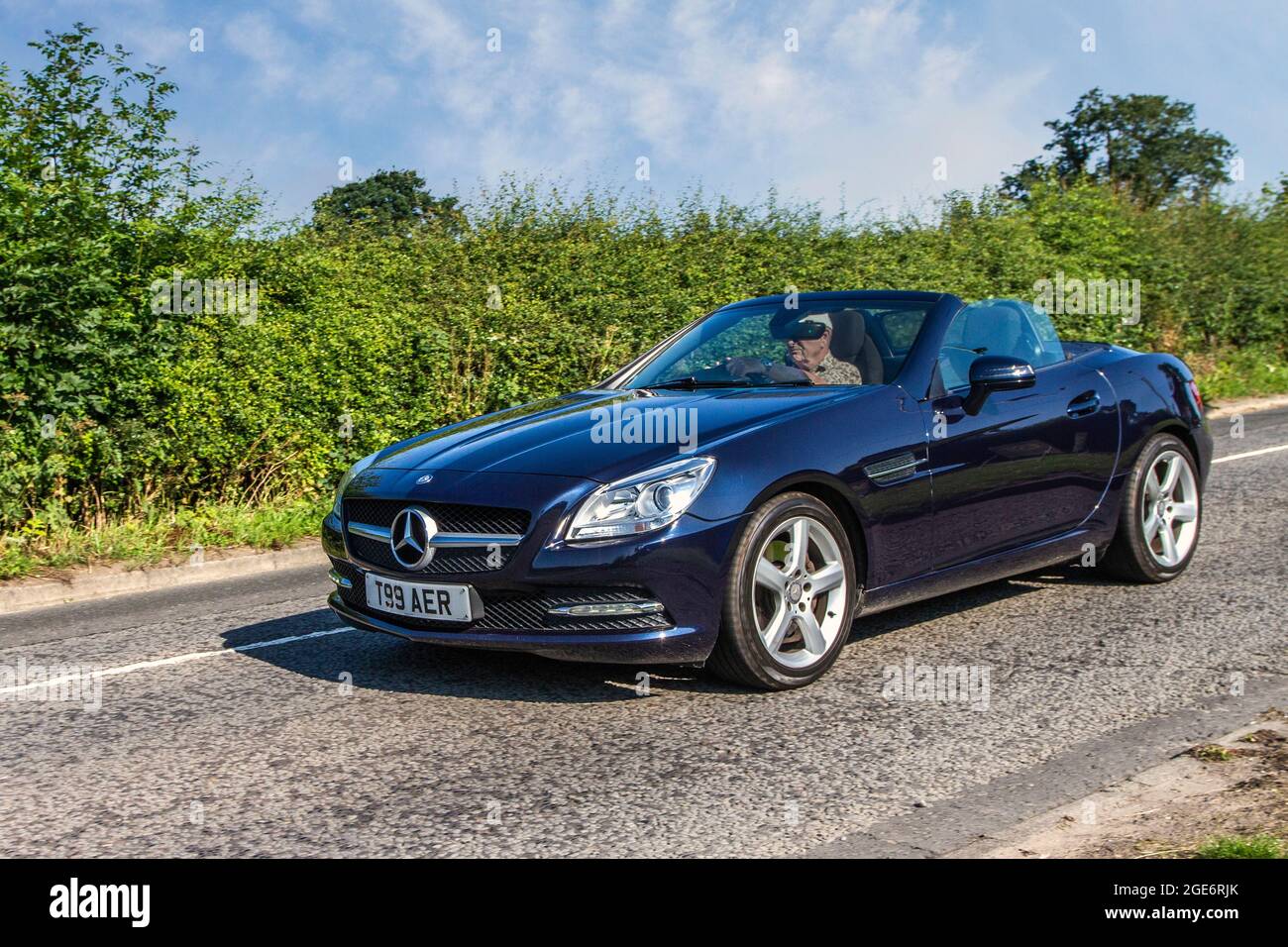 2012 Blue Mercedes-Benz SLK 7 speed sequential automatic 2143cc 2dr cabrio en-route to Capesthorne Hall classic July car show, Cheshire, UK Stock Photo