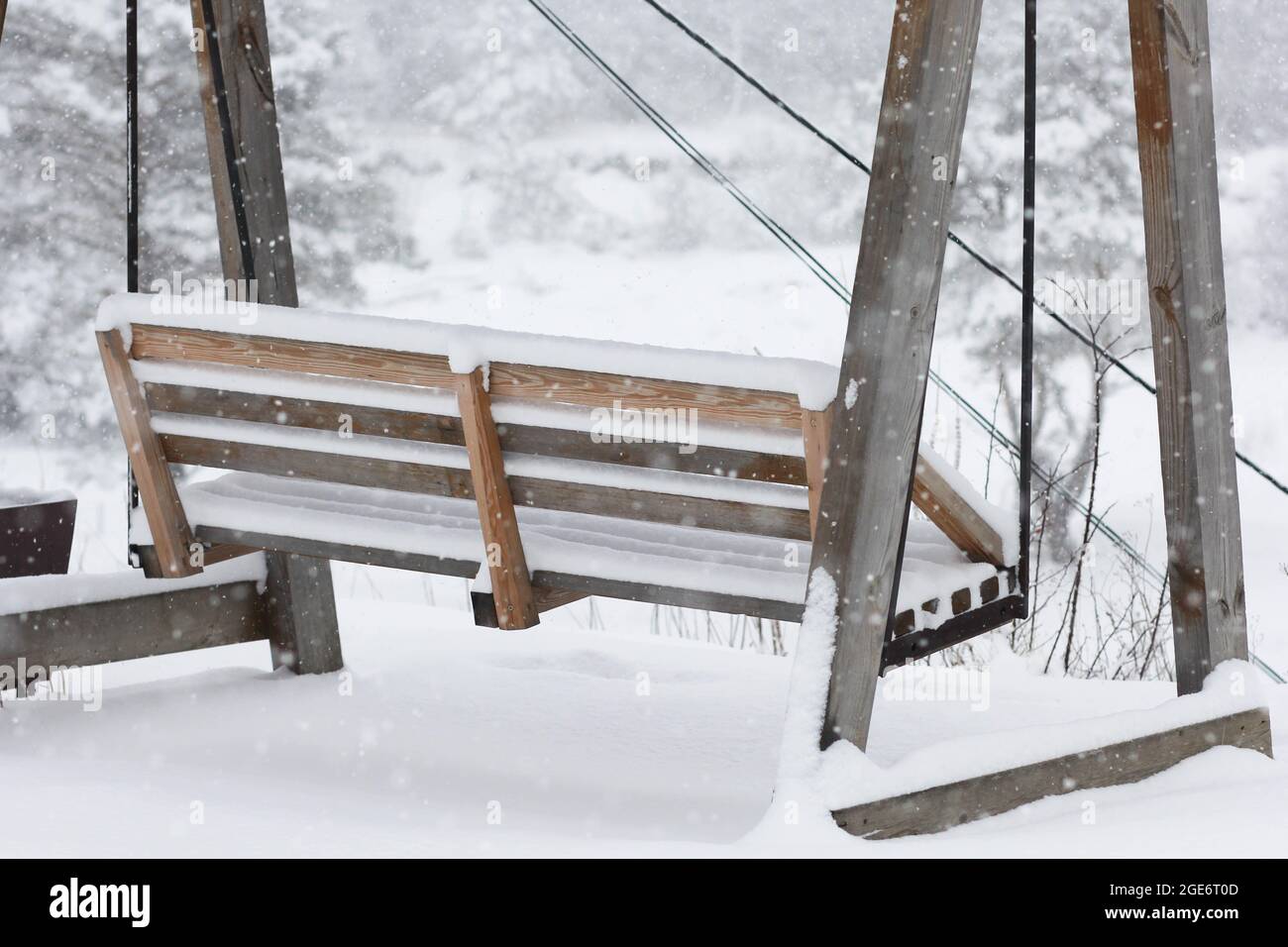 Bench swing covered by snow on snowdrifts in winter time on snowdfrifts ...