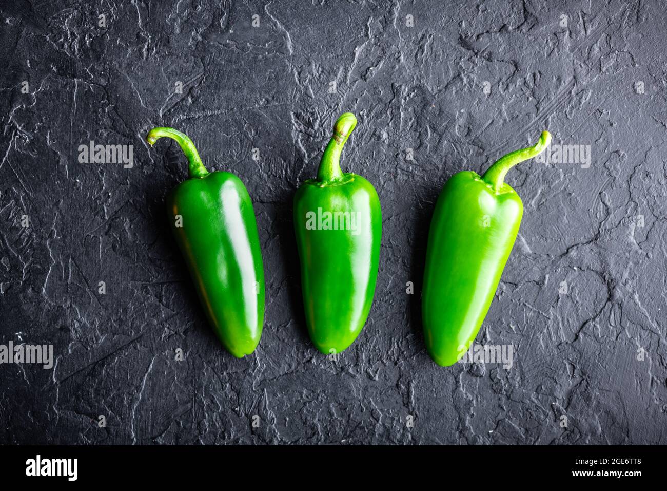 Green jalapeno hot pepper on black background closeup. Food photography Stock Photo