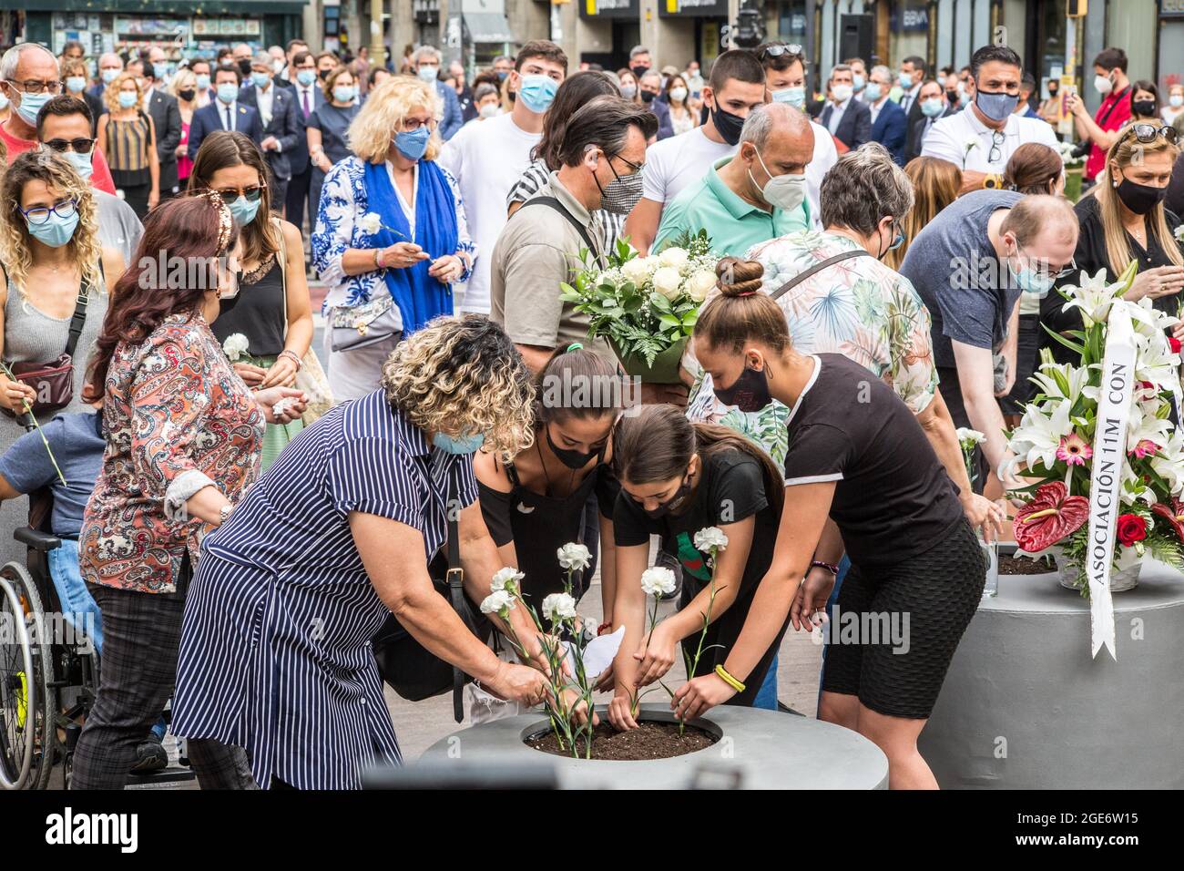 Barcelona, Catalonia, Spain. 17th Aug, 2021. Families of the victims of the jihadist attack on La Rambla are seen laying flowers at the anniversary ceremony of the attack.Barcelona pays tribute to the victims on the fourth anniversary of the jihadist attack on La Rambla where on August 17, 2017, a van carried out the massive outrage, which caused the death of 15 people.The families of the victims have been the protagonists of the ceremony, depositing white carnations and bouquets of flowers in three cylinders. This was followed by the authorities, with the mayor of Barcelona, Ada Colau, the Stock Photo
