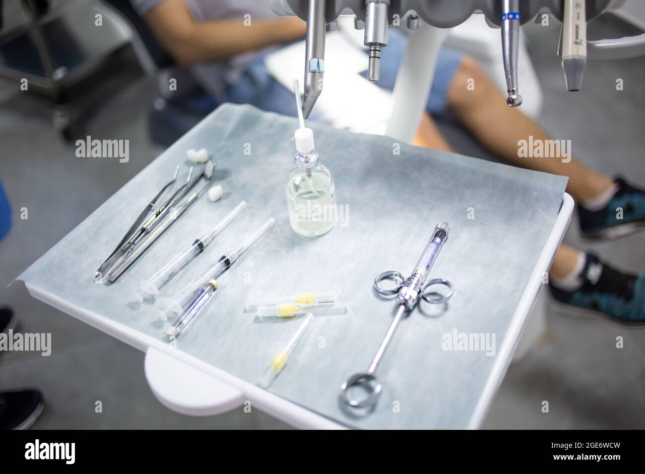 Medical tray table with dental tools, medicines and equipment, patient in a dental chair on a