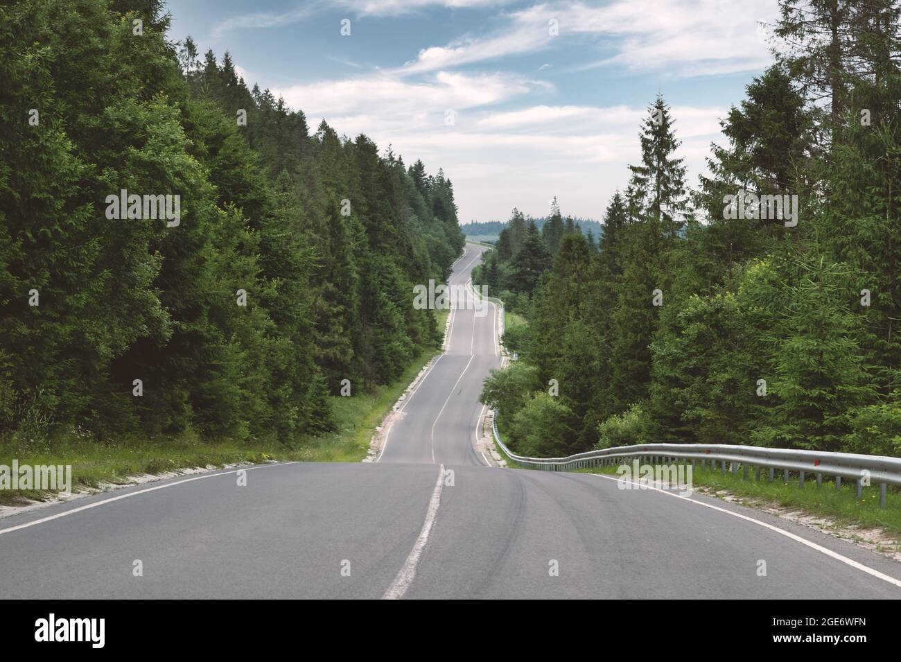 Curvy mountain road serpentine in green summer forest. Ukraine, Carpathian mountains. Landscape photography Stock Photo