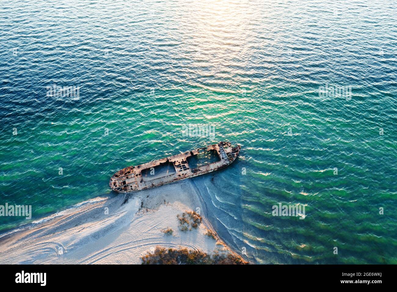 Old shipwreck reinforced concrete barge abandoned stand on beach on the coast of Black sea in Ukraine Stock Photo