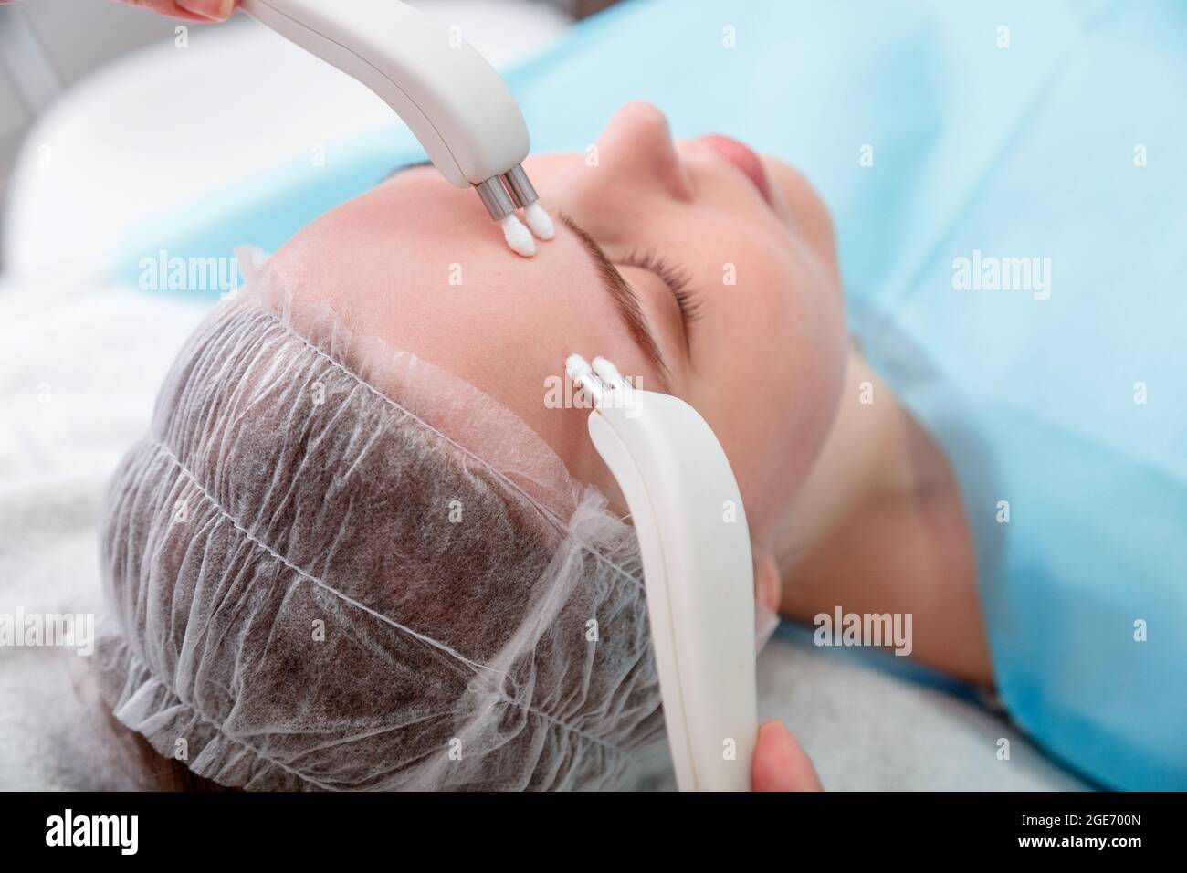 Microcurrents cosmetology beauty procedures. Aesthetics facial therapy microcurrents. Cosmetology services for young woman. Aesthetics cosmetology of Stock Photo