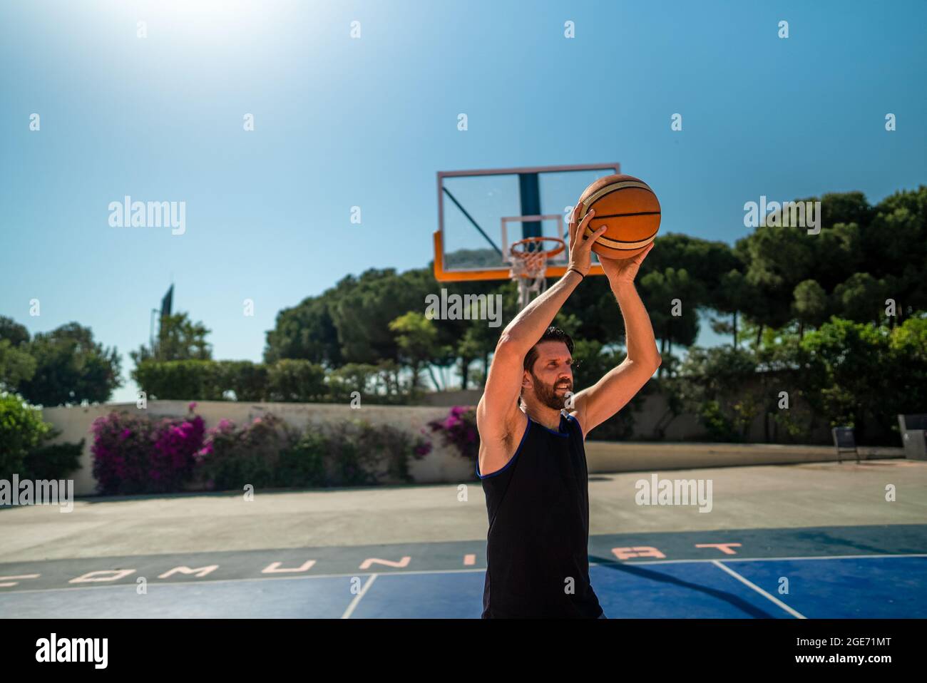 a basketball player throws a ball that to another player. pass in the game. Stock Photo