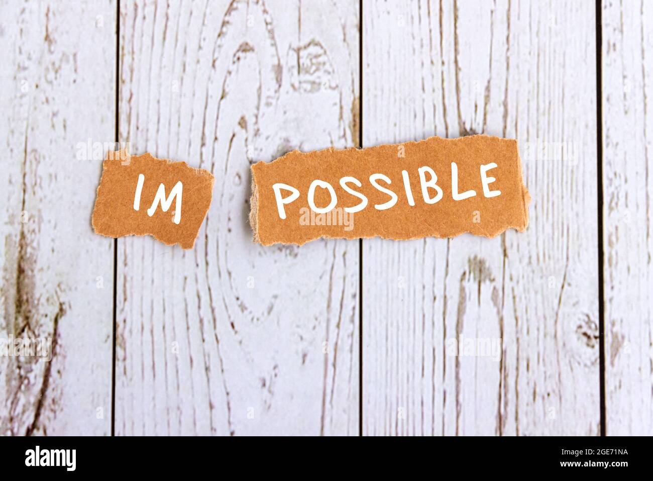 Impossible text on torn paper - conquering adversity concept Stock Photo