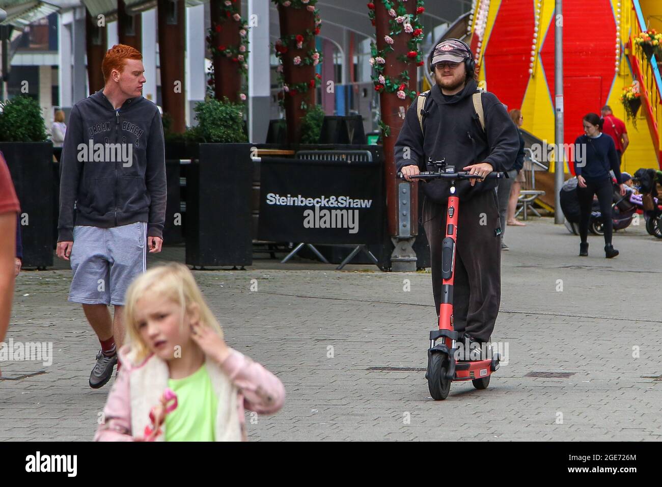 Bristol, UK. 16th Aug, 2021. A man riding a VOI electric escooter on a