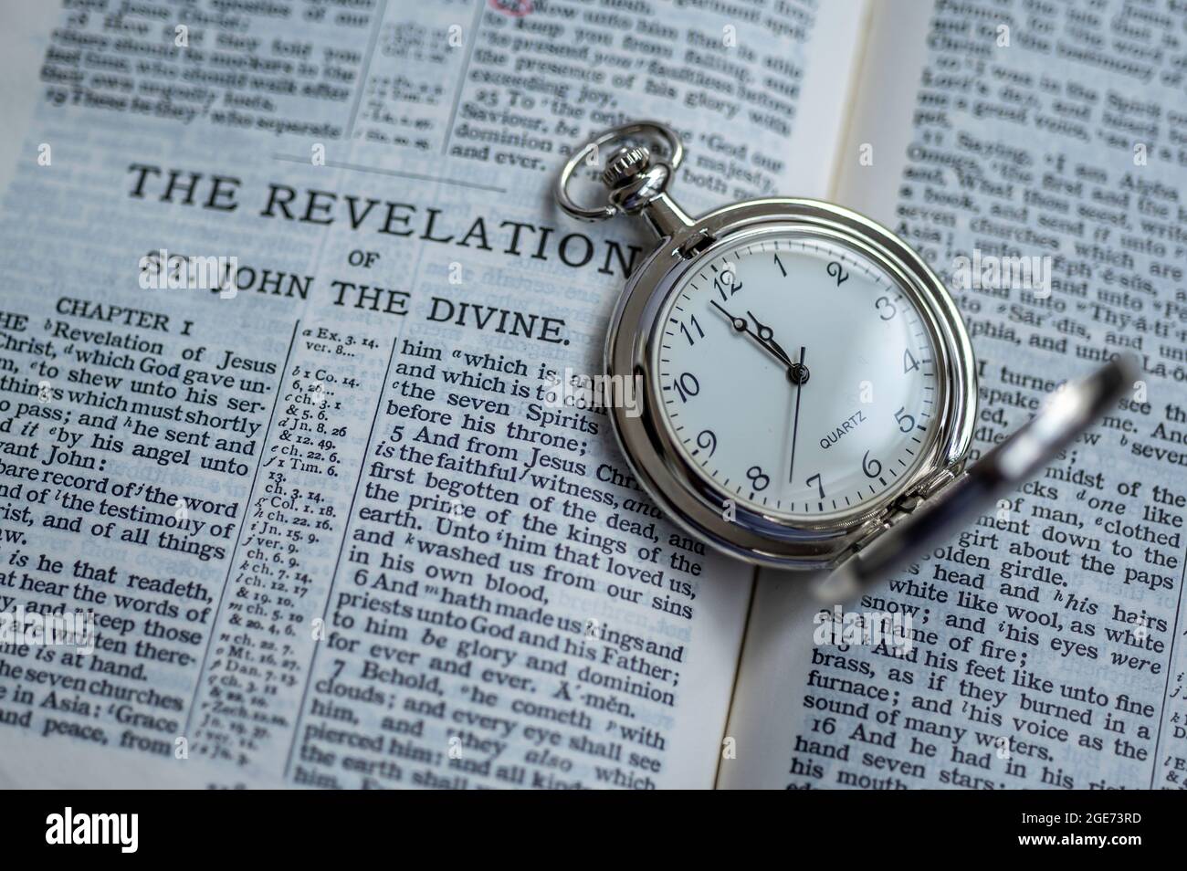 Open bible and a pocket watch Stock Photo