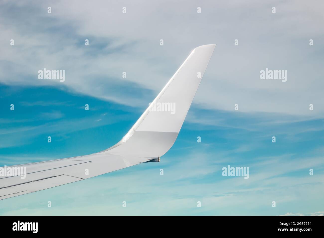 Plain wing over blue sky flight from helsinki to amsterdam stock photo