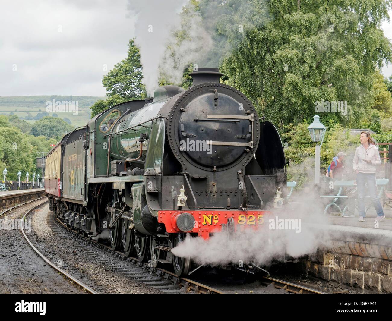 A steam train hauled by S15 class steam loco No.825 about to depart Grosmont Staion on the North York Moors Railway with a Whitby to Pickering train. Stock Photo
