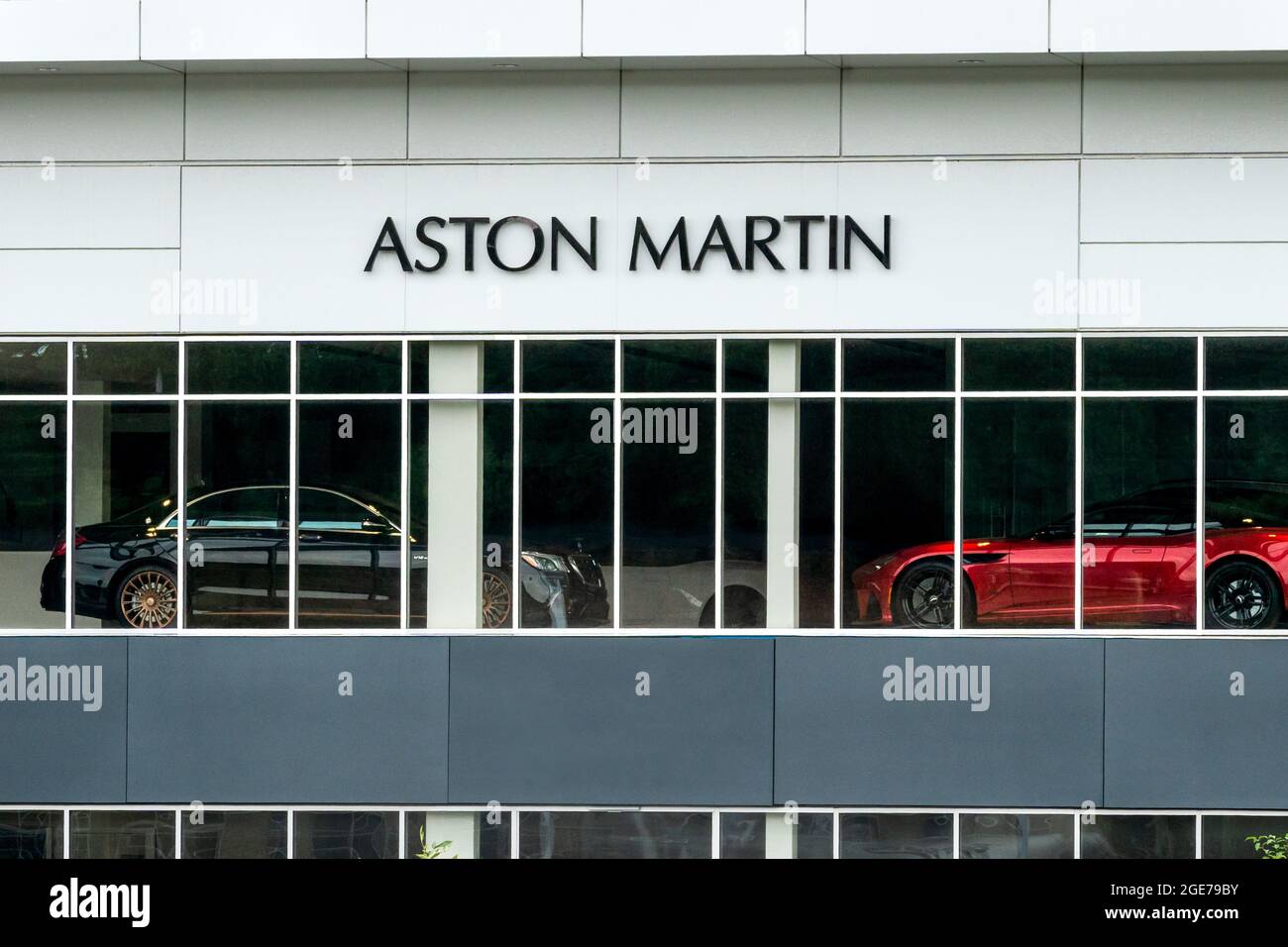 MINNEAPOLIS, MN, USA - AUGUST 8, 2021: Aston Martin Automotive Dealership Exterior and Trademark Logo. Stock Photo