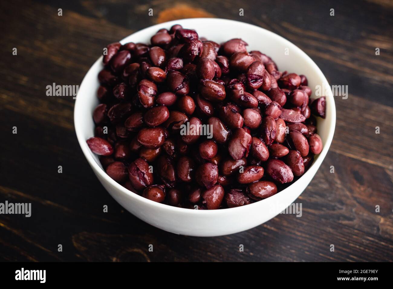 Small Bowl of Drained and Rinsed Canned Black Beans: Unseasoned cooked black beans in a small white ceramic bowl Stock Photo