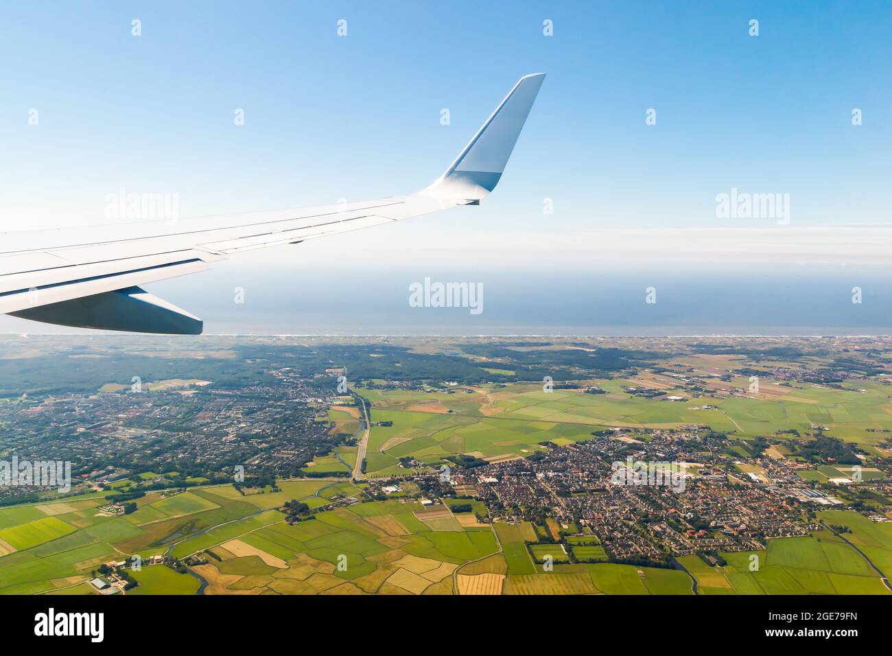 Plain wing over holland flight from helsinki to amsterdam stock photo
