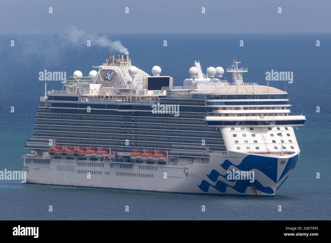 The huge Sky Princess cruise ship sits in waters off the coast of Torbay, Devon, UK. Stock Photo