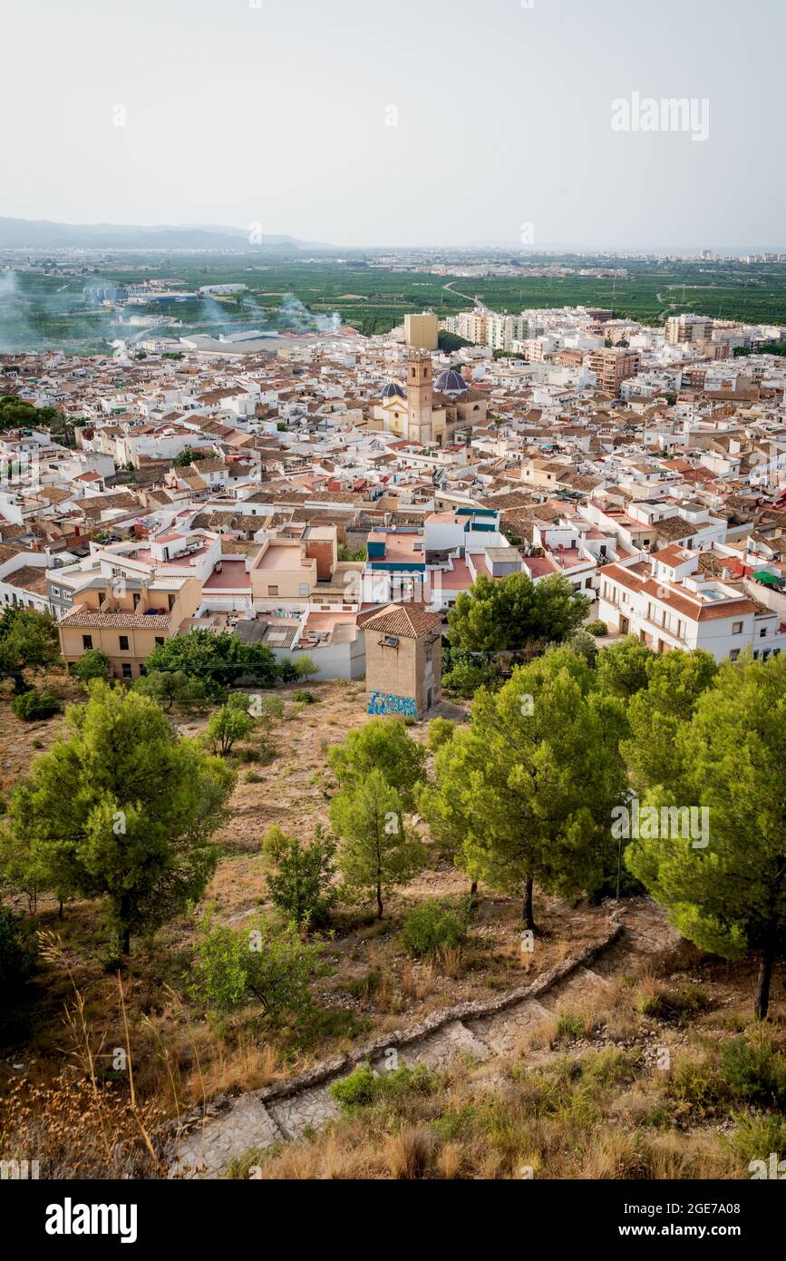 Top view from the castle 'Santa Anna' on the Spanish old town with the church tower and blue tiled domes of 'San Roque' in the center, Oliva, Spain Stock Photo