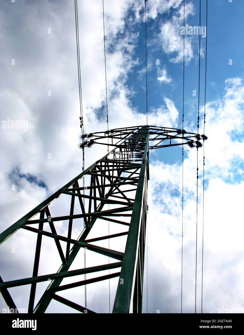 High voltage eletrical towers and lines with blue sky and clouds ...