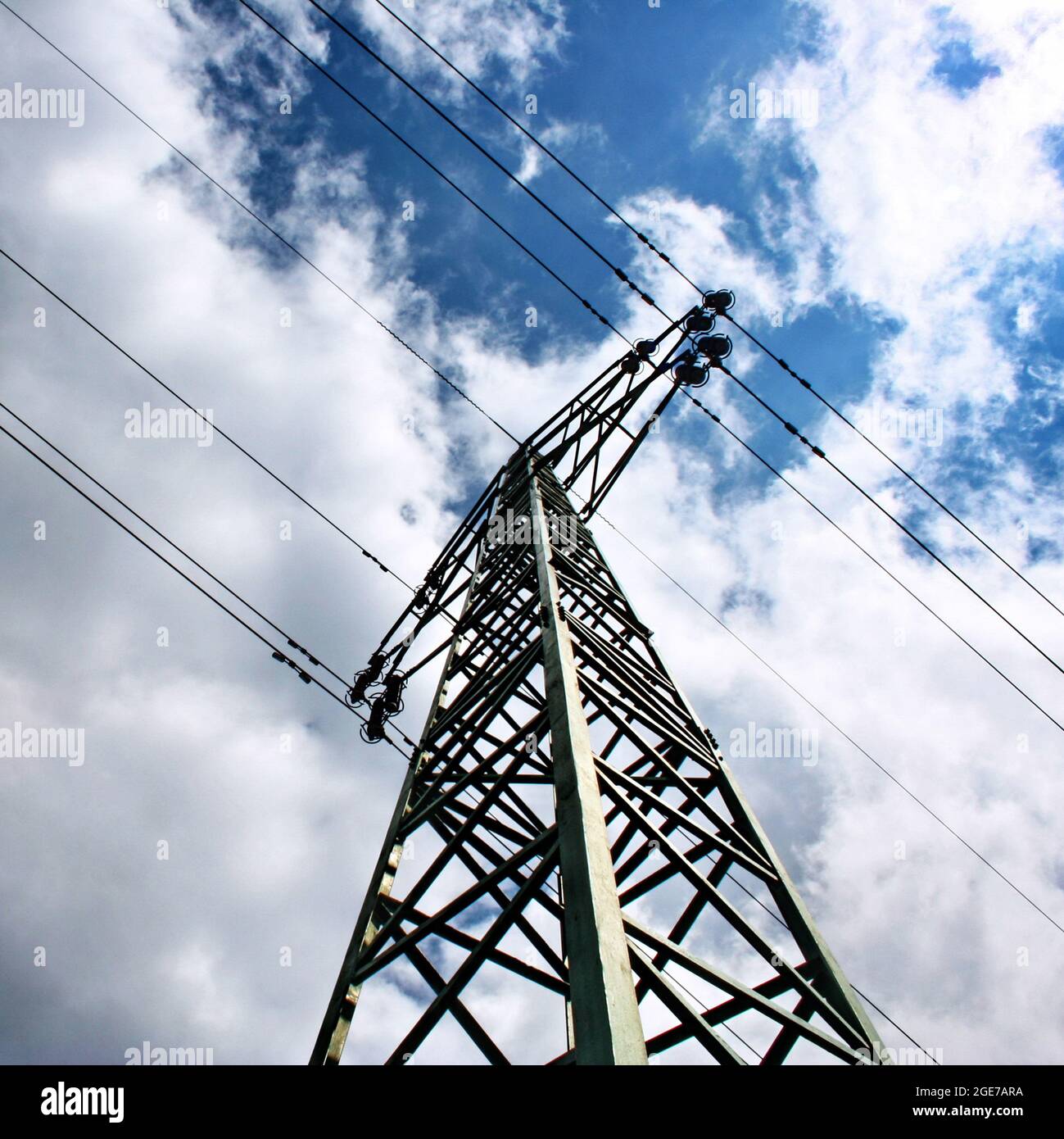 High voltage eletrical towers and lines with blue sky and clouds ...