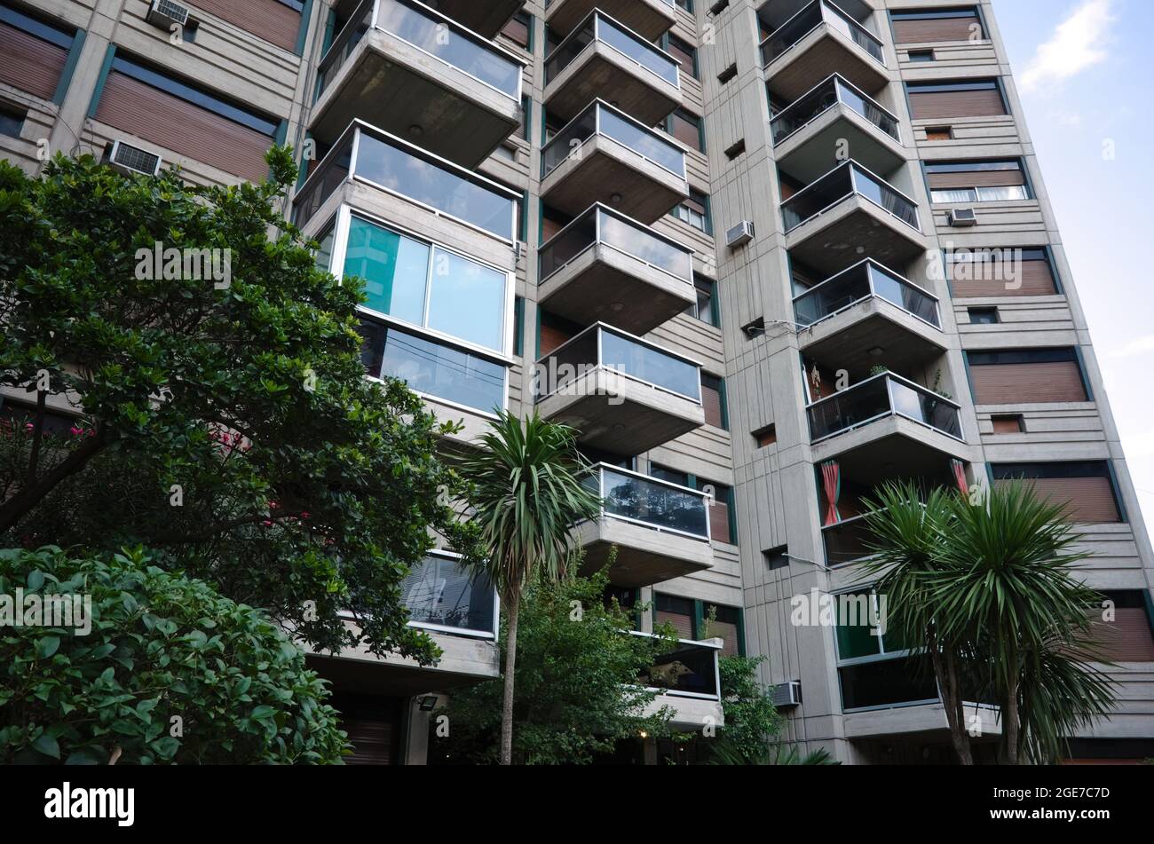 Exterior of modern multi-storey residential building in Cordoba, Argentina with glass balconies and typical Argentinian outside blinds on windows Stock Photo