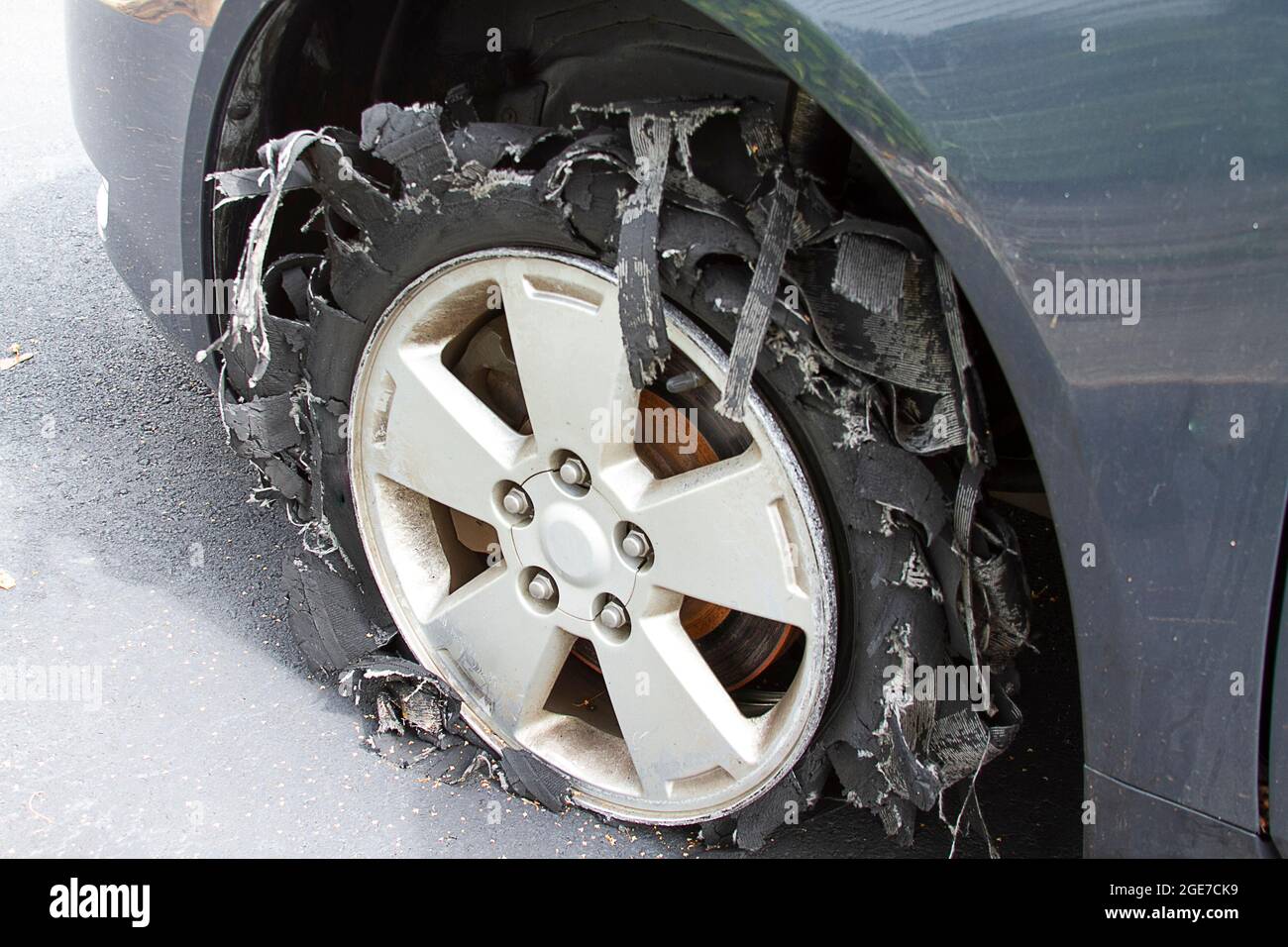 Severely blownout tire with rubber shredded to pieces Stock Photo Alamy