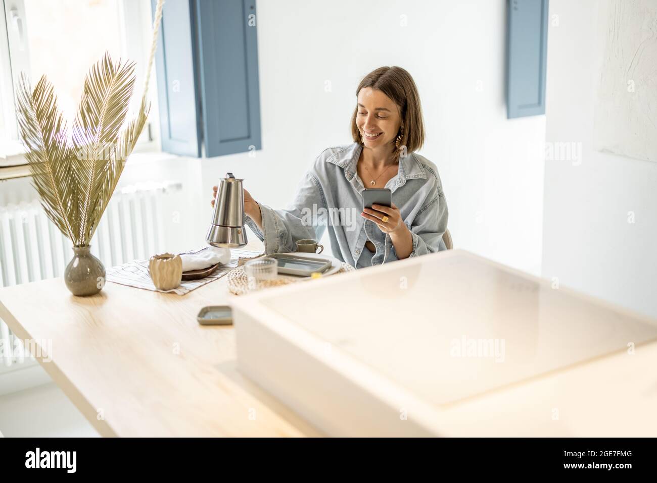 Woman having a breakfast at modern apartment Stock Photo